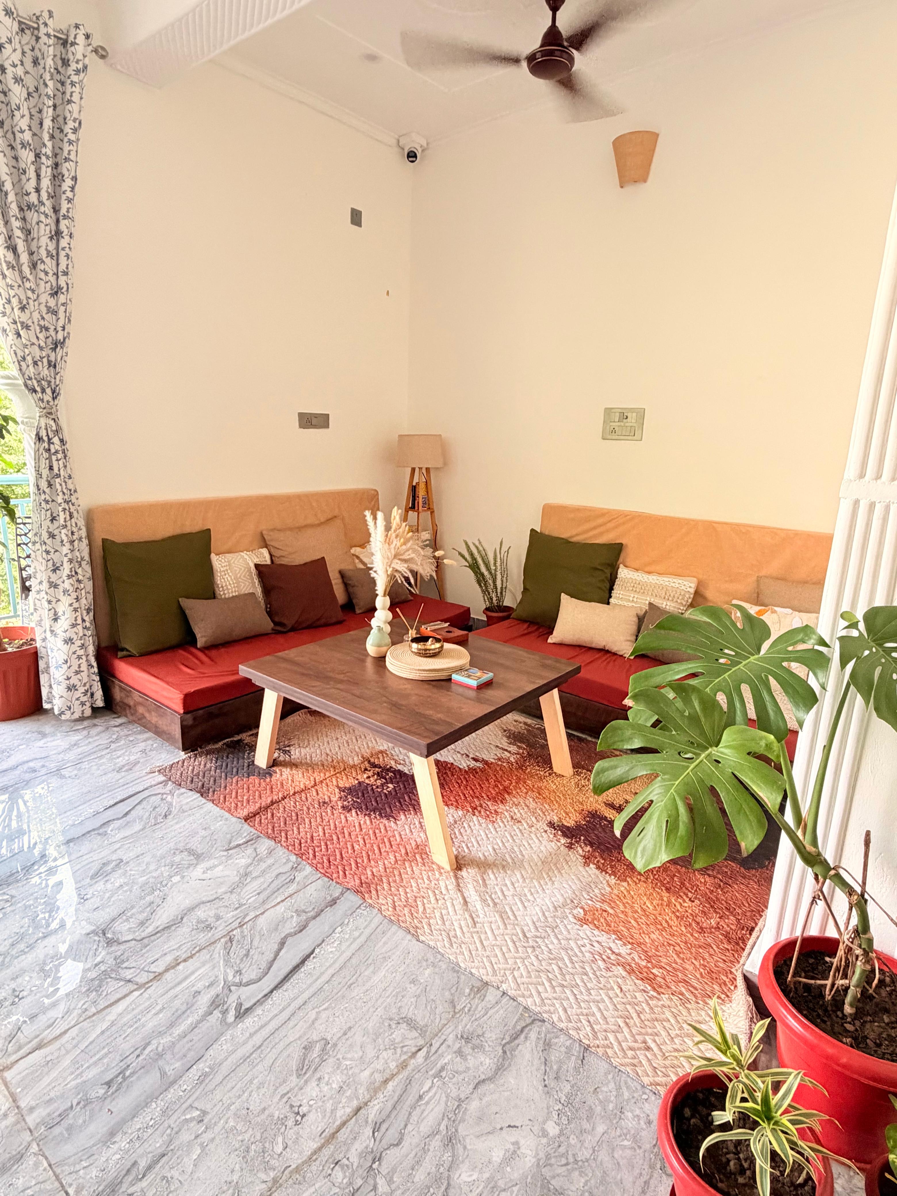 Common seating area at Aahista Stays